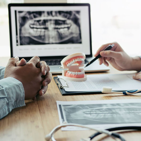 Dentists are discussing dental problems at report x-ray image on Dental restoration